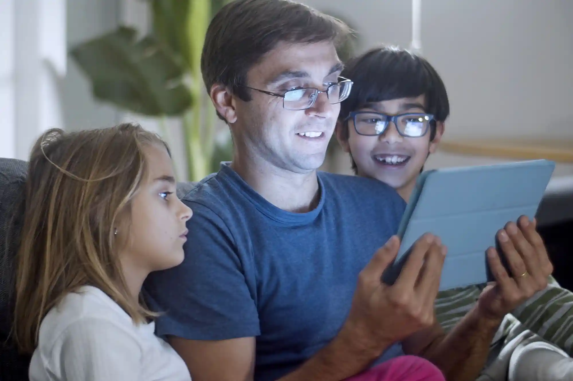 Parent helping child use a laptop
